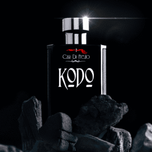 Kodo perfume bottle on black stones.