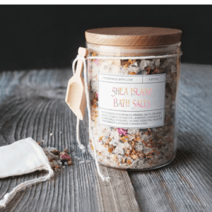 Jar of Shea Island bath salts with flowers.