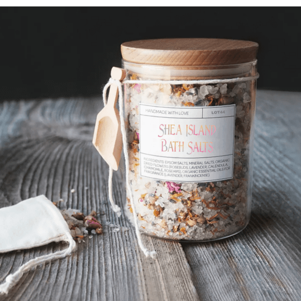 Jar of Shea Island bath salts with flowers.