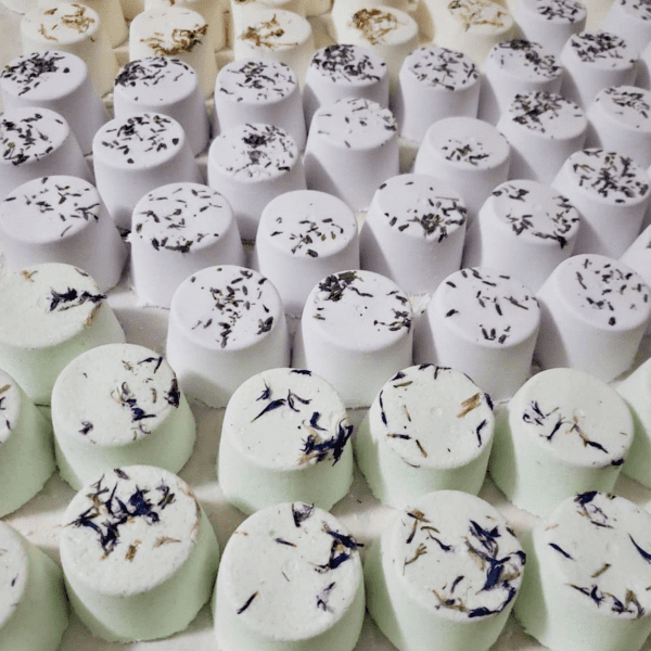 Assortment of bath bombs with lavender and herbs.