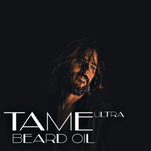 Man with beard using Tame Ultra beard oil.