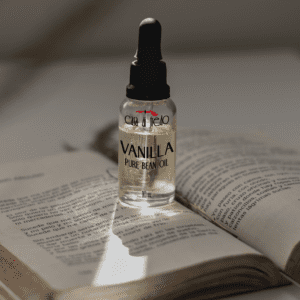 Vanilla bean oil bottle on open book.