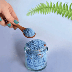 Blue bath salt in a wooden spoon.