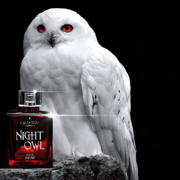 White owl with red eyes and perfume bottle.