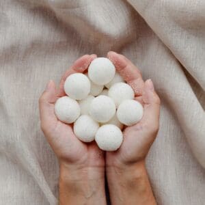 Hands holding white balls with dots.