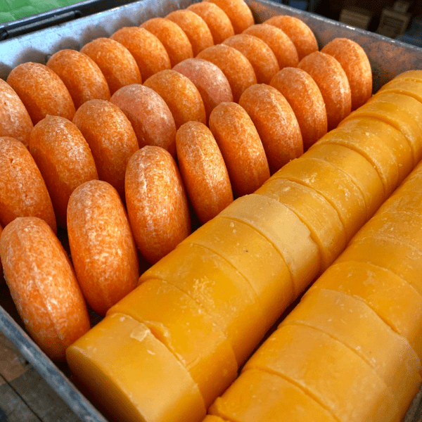 Orange and yellow soap bars in a tray.