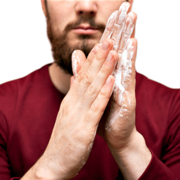 Man with beard washing hands with soap.