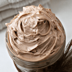 Close up of creamy chocolate butter in a jar.