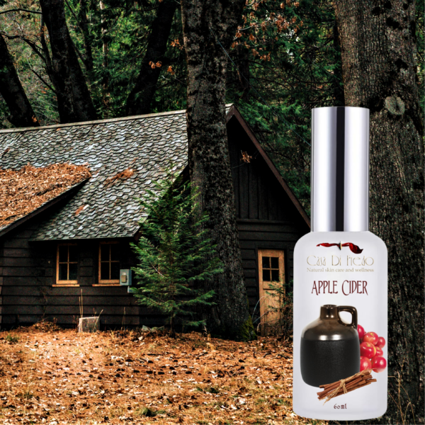 Apple cider skin care bottle in front of cabin.